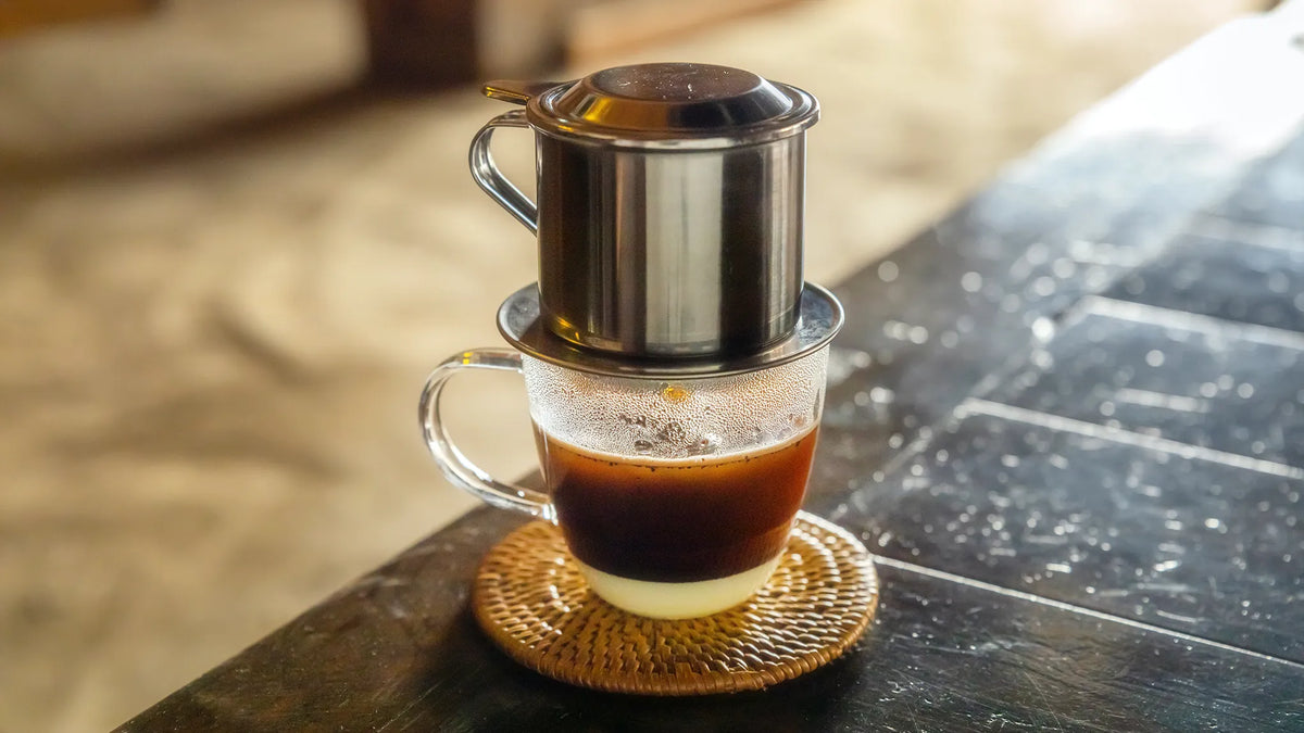 Vietnamese coffee brewed with a traditional phin filter, sweetened with condensed milk.
