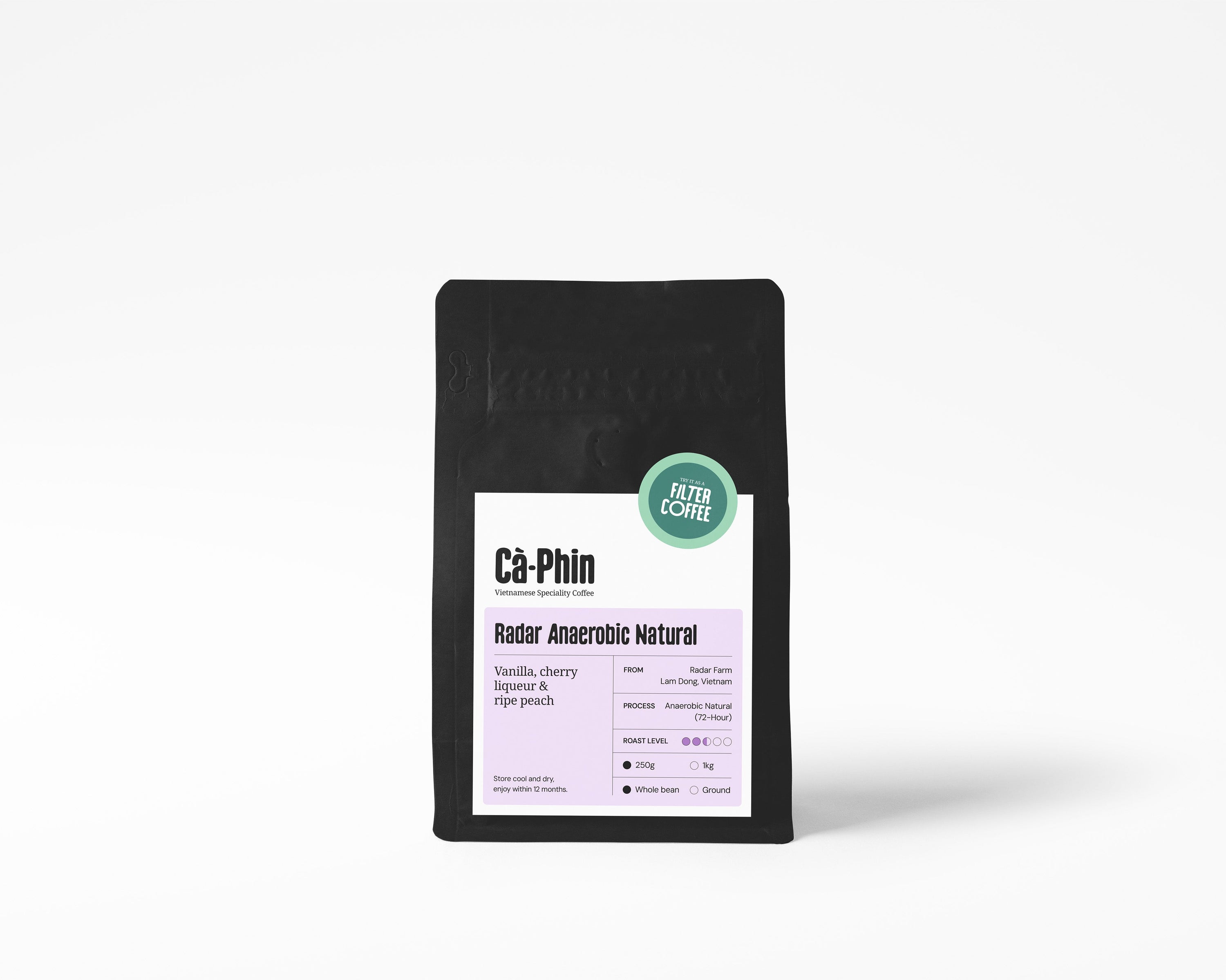 A black stand-up pouch of Ca Phin Radar Anaerobic Natural coffee, featuring a white and light purple label with a green circular 'Try it as Filter Coffee' badge, set against a plain white background.